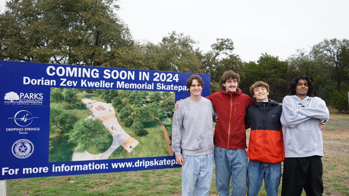Dripping Springs skate park attendees pose with the construction plans in Founders Park.