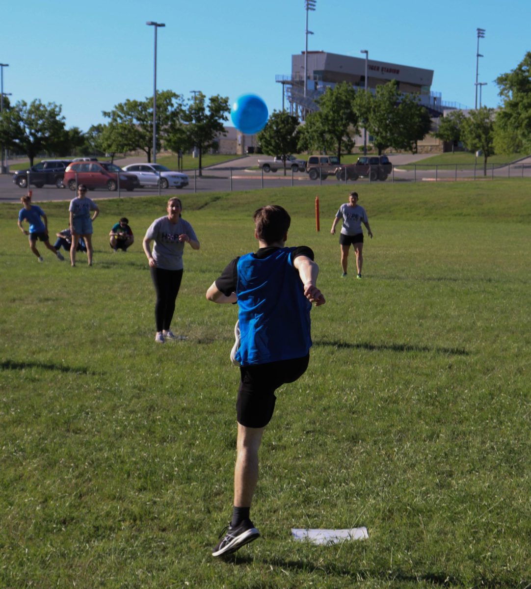 American Studies team player punts kickball towards pitcher.