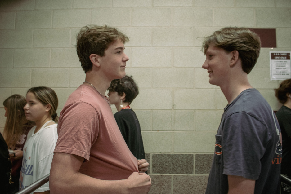 Two students discussing dress code during lunch